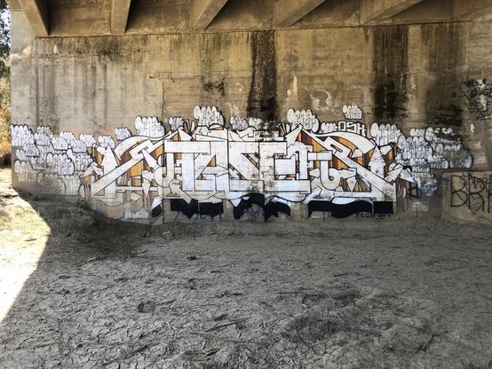 Spray painted art on the side a weir pillar/wall