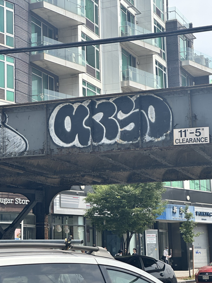 ANSO in black 3d bubble letters with a white outline on a bridge
