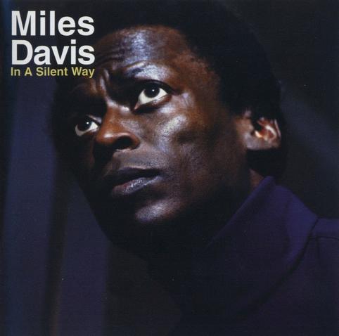 Cover of 'In A Silent Way': photographic portrait of the artist against a dark background.