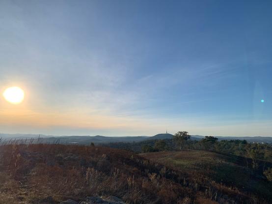 Picture from top of Red Hill out towards Black Mountain in late afternoon with sun low in the sky