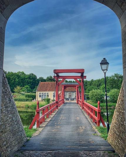 A view of one of many red-coloured lift bridges at Fort Bourtange, the Netherlands.