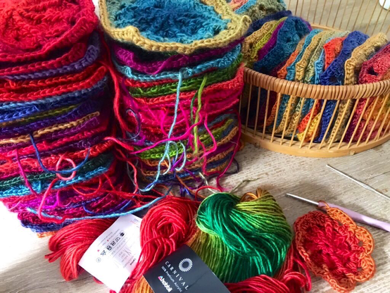 Granny squares in multitude of colours.  It is sweater in the making. Colours are bright like Carnival in Rio.