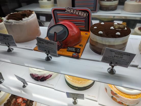 A cake shaped like the red imposter from Among Us.