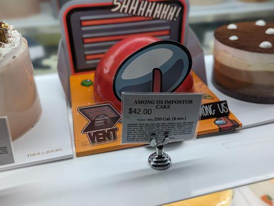 A cake shaped like the red imposter from Among Us.