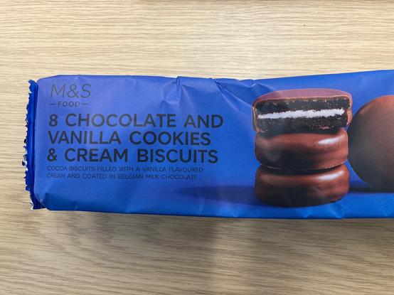 A packet of M&S chocolate and vanilla cookies & cream biscuits.