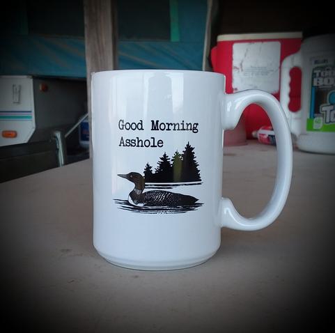 A coffee mug that reads "Good morning, asshole."