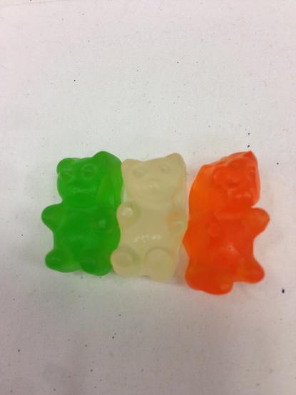Gummi bears lined up in the colors of the flag of Ireland