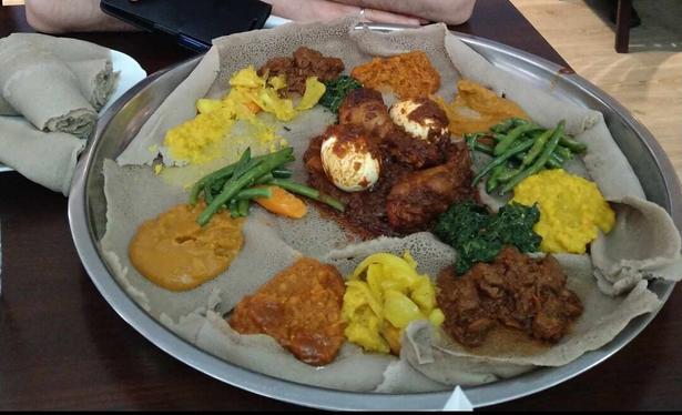 Injera with doro wat and other Eritrean/Ethiopian foods.