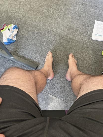 Man’s bare feet with dirty socks laying to the left.