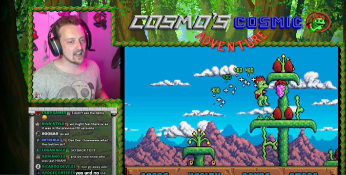 A screenshot of Dosgamert as he's playing a beta of the upcoming Cosmo's Cosmic Adventure HD remaster. Cosmo is jumping up and collecting the colorful fruits - huge berries and grapes.