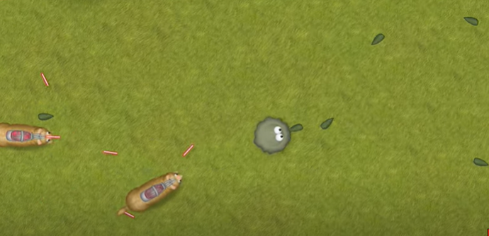 A screenshot of the 2010 Windows game Tasty Planet: Back for Seconds showing the little gray ball of goo with eyes that you move around, eating and collecting things with. It's on a green background with some of the other little things you eat behind the ball of goo.