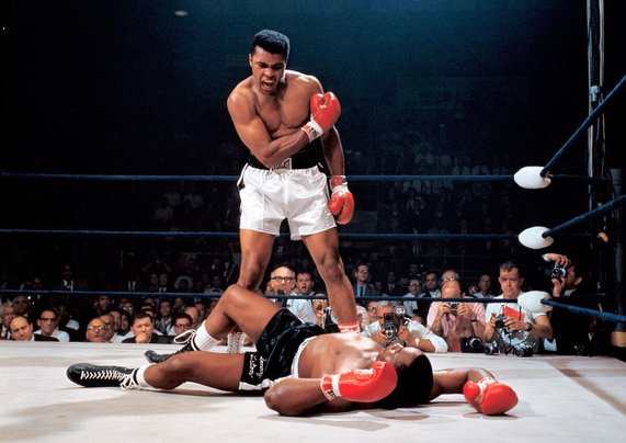 Photo: Standing, alert, special prosecutor MUHAMMAD ALI; on the canvas, knocked out, SONNY LISTON (1965).