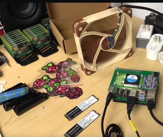 A deskwith several stacks of Raskberry Pi CM4's on it!
