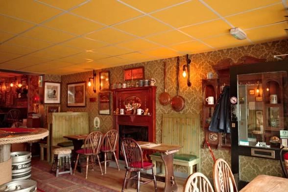 The cosy interior of an artfully cluttered Victorian style pub.