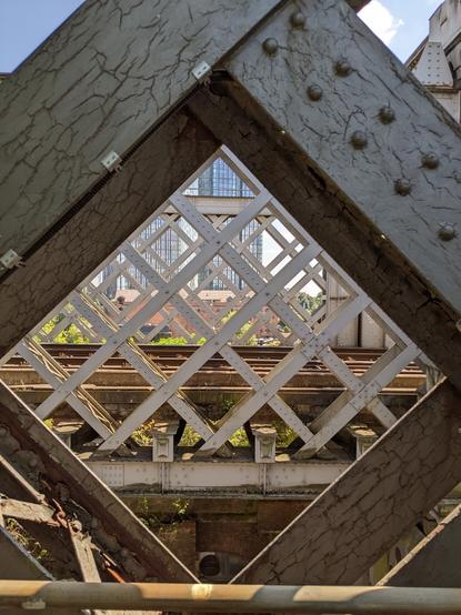 Castlefield Viaduct view through the ironwork to the tram tracks and beyond. Manchester UK.