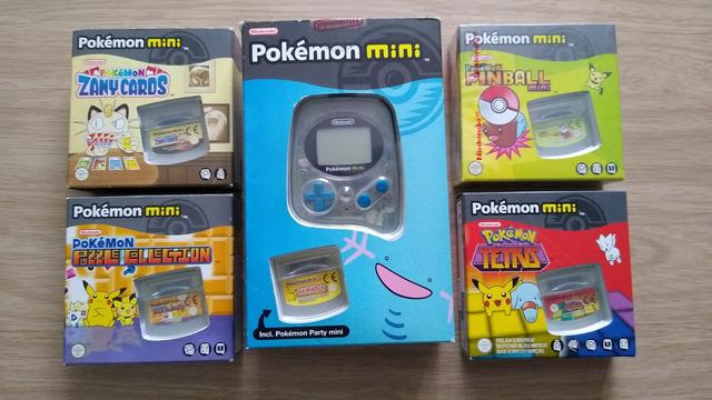 A boxed Wooper Blue Pokémon Mini console, with several English released titles.