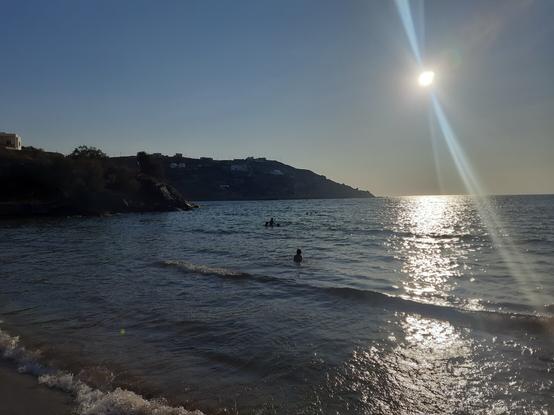 Sun shining above the sea at Kini, Syros