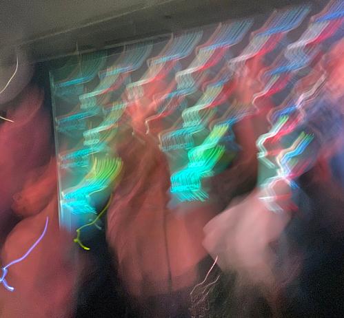 Blurry picture of streaky colors and people dancing