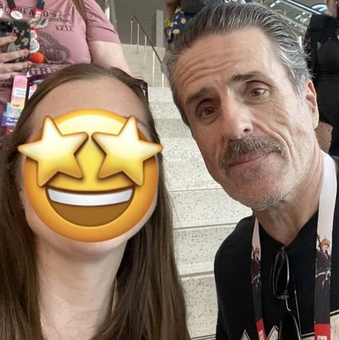 Selfie of two people facing the camera - me with a star-eye emoji over my face and Con O'Neill in a black t-shirt