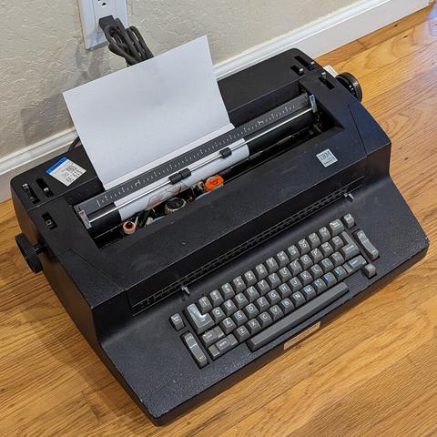 Full view of a black and grey IBM Selectric II typewriter