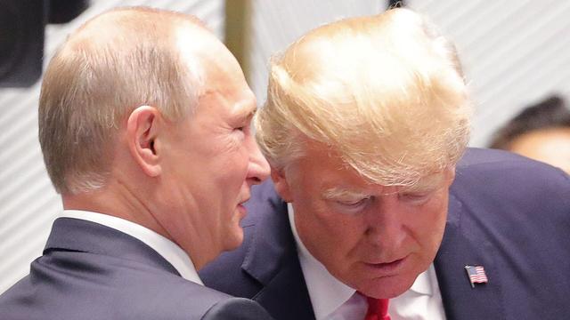 Photo: Putin whispering in President Donald Trump’s right ear, as Trump leans down slightly to listen.