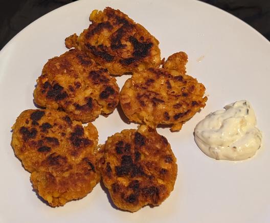 Mashed chickpea fritters on a plate with vegan tartar sauce