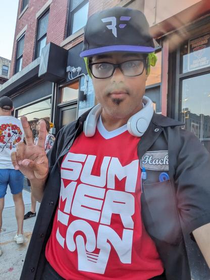 DCG 201 Co-Founder Sidepocket outside of Canal Bar in Brooklyn wearing his SummerCon 2023 Staff shirt and his Bishop Fox hat.