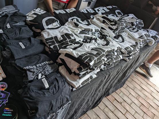 Attendee shirts at the Registration Desk at SummerCon 2023.