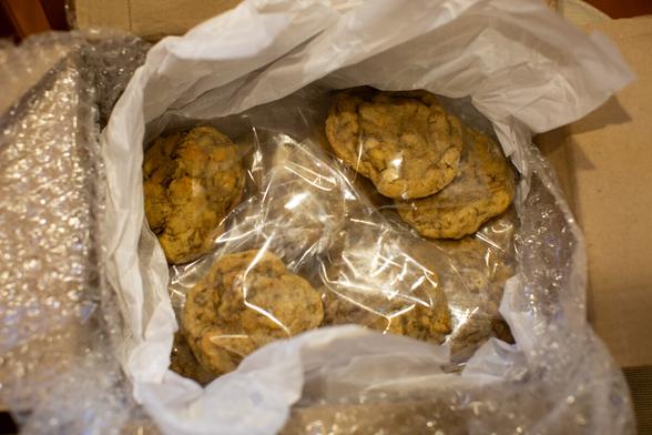 Box of gooey raisin cookies wrapped in plastic.