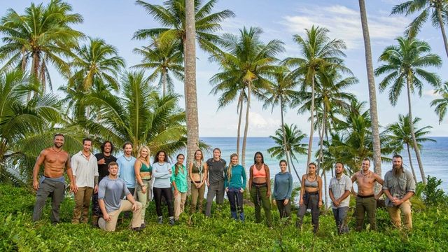 The cast of The CW/The Roku Channel competition series "Fight To Survive" posing with a tropical backdrop.
