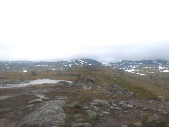 Fjell med toppene dekket av tåke eller lave skyer