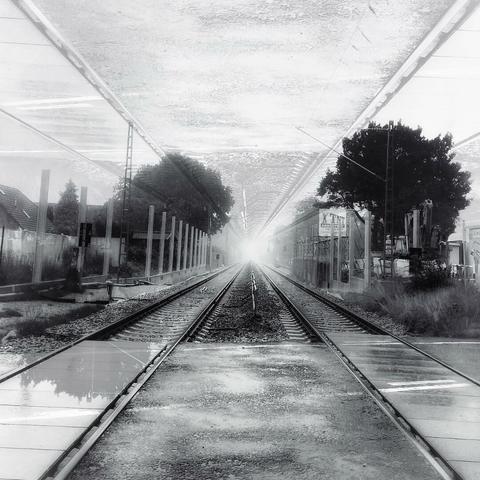 A b/w double exposure photo of a railroad crossing in Oldenburg, Germany.