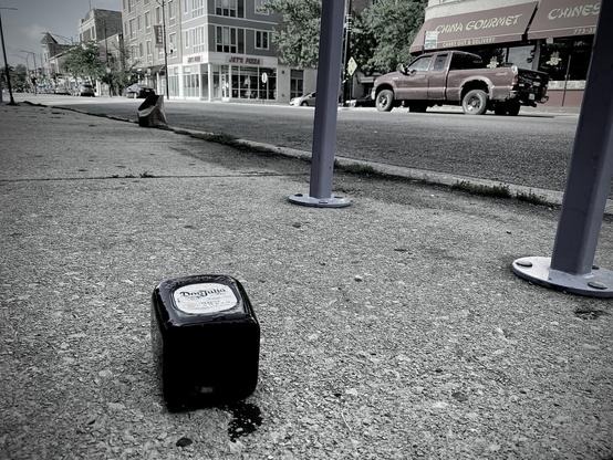 empty bottle of don julio liquor on the sidewalk