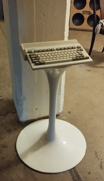 The white tuliplike base of Saarinen table - but without the plate - is standing in front of a white column. I put an Amiga 600 on it.
