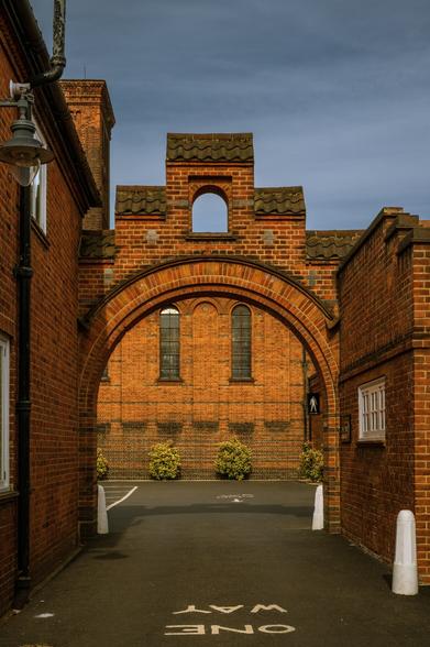 Golders Green Crematorium brick building lit by afternoon golden hour sun
Captured by Komeil Karimi