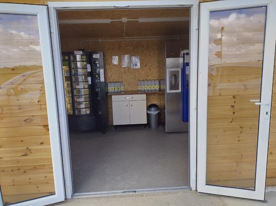 Image showing milk dispenser in wood cabin