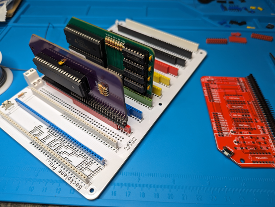 RC2014 Z80 computer kit with backplane, CPU module, and 512k ROM/RAM modules assembled and installed. Laying on the soldering mat next to it is the real-time clock PCB partially assembled.