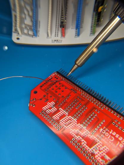 Soldering the header pins to the red RTC module.