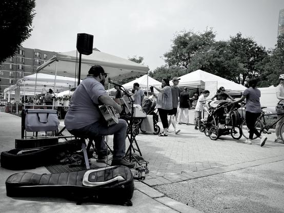 lone guitarist pierce crask performing at the farmers market in skokie, illinois