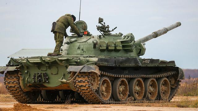 Citizens called up during Russia's "partial" mobilization climb a T-62 tank as part of combat training at a military firing range. Vladimir Smirnov / TASS