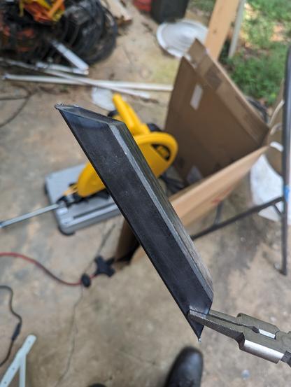 A 1 1/4" inch square tube with 45 degree angles cut from each end as a demonstration that the chop saw is better than I am at cutting metal.