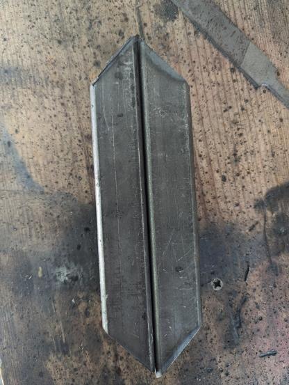 Two matching 1 1/4" square tube pieces with 45s cut in each end. They're extremely symmetrical thanks to the new chop saw, which shows how terrible I am at cutting metal by hand. :)