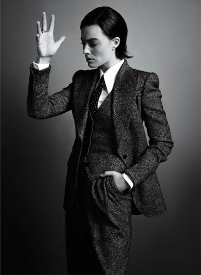 A black and white picture of Margot Robbie wearing a suit.