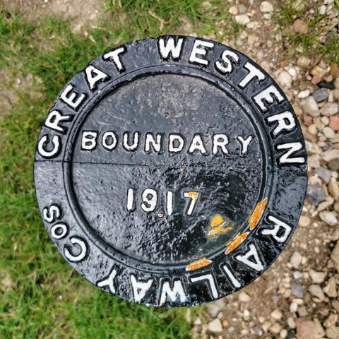 Circular black boundary marker with 'Great Western Railway Cos' around the circumference and 'Boundary 1917' in the middle picked out in white.