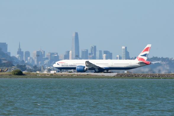 BA Boeing 777 about to lift off in front of the San Francisco skyline