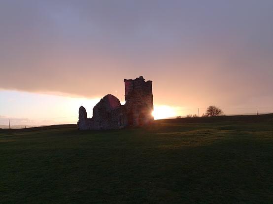 A medieval church at sunset on an iron age hill fort