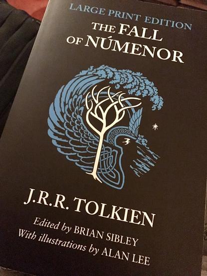 Cover of the book, edited by Brian Sibley and illustrated by Alan Lee. The cover has a black background and shows a blue wave wading over a white tree.