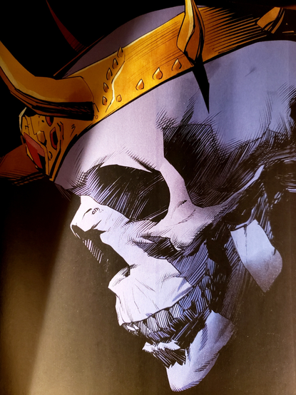 Art from Once & Future vol 3, The Parliament of Magpies, a graphic novel by Kieron Gillen and Dan Mora. It is an image of a human skull wearing a gold crown.