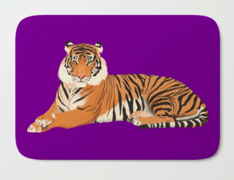Our tiger mascot is shown with a purple background on a bath mat.