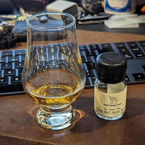 Fettercairn 12 Year Old piured in a Glencairn glass for tasting. Comes from a bottle that was part of a holiday Scotch sampling kit.